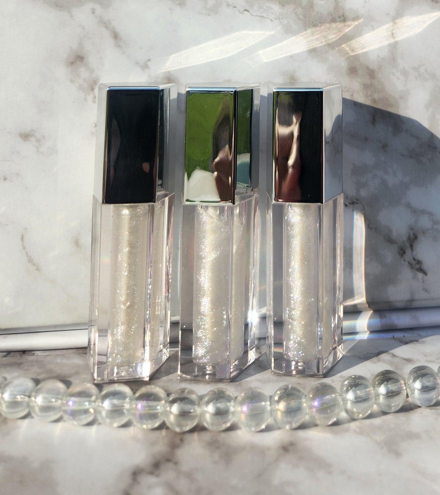 Elohim (sheer shimmering pearl lip gloss) Silver tube